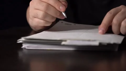 Close-up of Hands with Pen on Paper Documents Sitting Stock Footage 151473769
