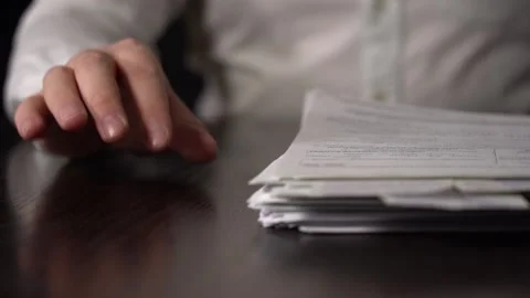 Close-up of Hands with Pen on Paper Documents Sitting Stock Footage 166503269
