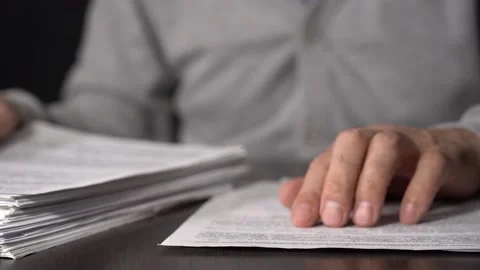 Close-up of Hands with Pen on Paper Documents Sitting Stock Footage 167887434