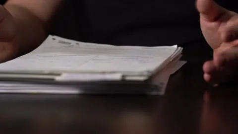 Close-up of Hands with Pen on Paper Documents Sitting Stock Footage 169092077