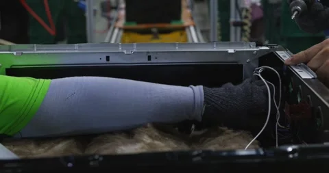 Close-up of hands of people assembling computer on conveyor belt 動画素材 255355245