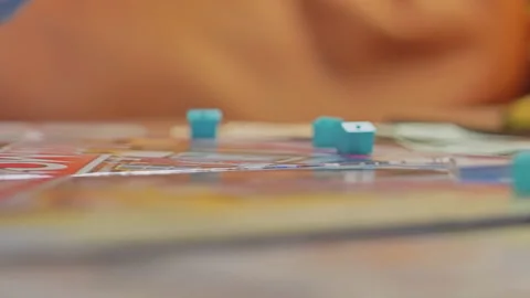 Close-up of the hands of people playing the game Monopoly. Stock Footage 140969697
