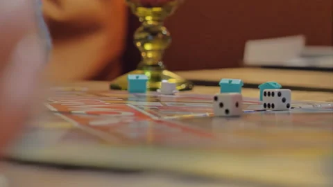 Close-up of the hands of people playing the game Monopoly. Stock Footage 140970051