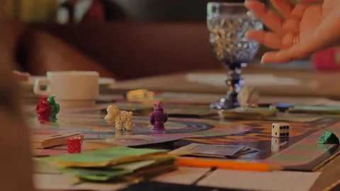 Close-up of the hands of people playing the game Monopoly. Stock Footage 140970138