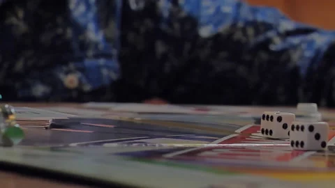 Close-up of the hands of people playing the game Monopoly. Stock Footage 140970239