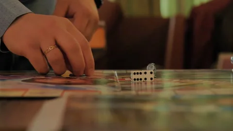 Close-up of the hands of people playing the game Monopoly. Stock Footage 140970685