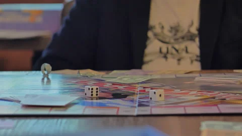 Close-up of the hands of people playing the game Monopoly. Stock Footage 140971414