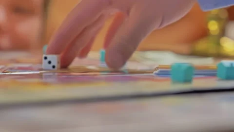 Close-up of the hands of people playing the game Monopoly. Stock Footage 140971574