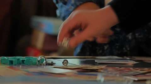 Close-up of the hands of people playing the game Monopoly. Stock Footage 140971644