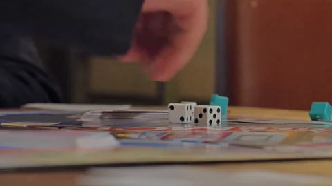 Close-up of the hands of people playing the game Monopoly. Stock Footage 140971730