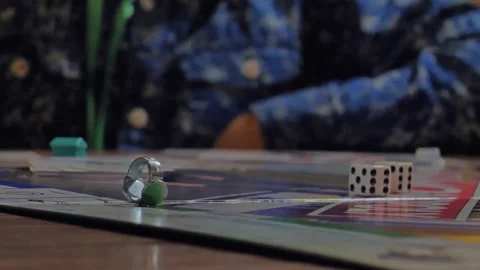 Close-up of the hands of people playing the game Monopoly. Stock Footage 140971811