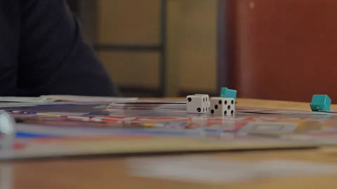 Close-up of the hands of people playing the game Monopoly. Stock Footage 140972171