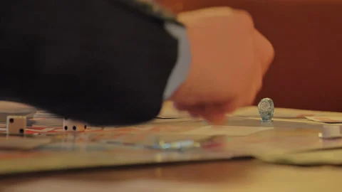 Close-up of the hands of people playing the game Monopoly. Stock Footage 140972683