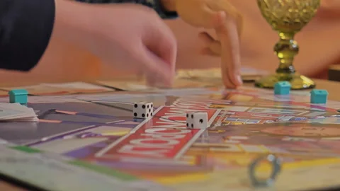 Close-up of the hands of people playing the game Monopoly. Stock Footage 140972742