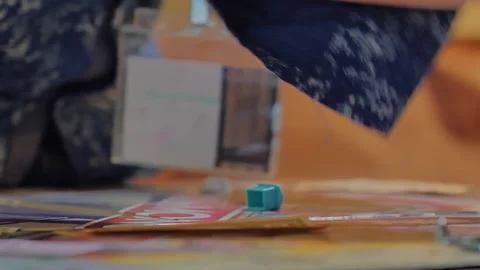 Close-up of the hands of people playing the game Monopoly. Stock Footage 140972988