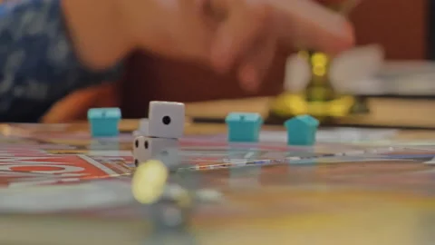 Close-up of the hands of people playing the game Monopoly. Stock Footage 140973046