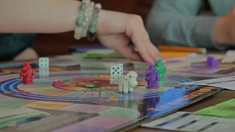 Close-up of the hands of people playing the game Monopoly. Stock Footage 140973557