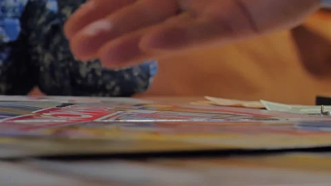 Close-up of the hands of people playing the game Monopoly. Stock-Footage 140973646