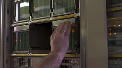 Close-up of hands performing maintenance on sophisticated electrical Stock Footage 274828713