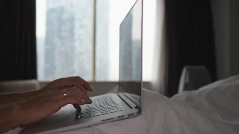 Close up of hands of a person in bed typing on laptop. Home office concept Video stock 157056178