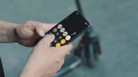 Close-up of hands with phone. alculator app on the phone Video stock 229257547