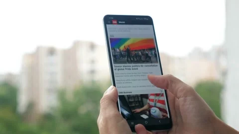 Close-up hands with a phone and watching the latest news. A woman monitors the Video stock 209653853