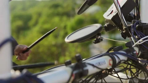 Close up of hands picking up drumsticks on an electronic drum kit outdoor Stock Footage 243639649
