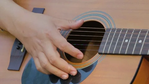 Close up of hands picking the guitar strings slow motion Stock Footage 76009974