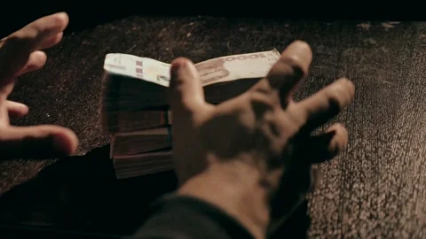 Close-up of hands picking up several stacks of money Stock Footage 284442619