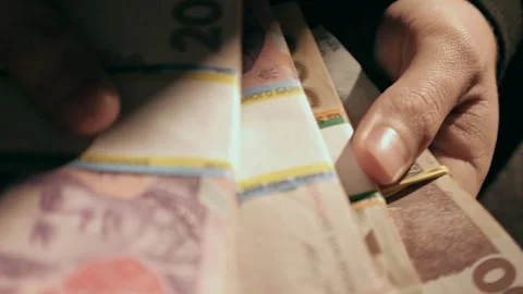 Close-up of hands picking up several stacks of money Stock Footage 284443734
