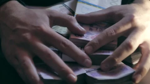 Close-up of hands picking up several stacks of money Stock Footage 284444350
