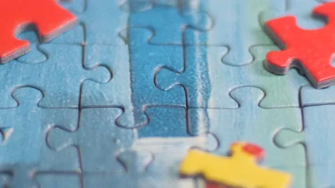 Close Up of Hands Placing Blue Puzzle Piece Stock Footage 148540364