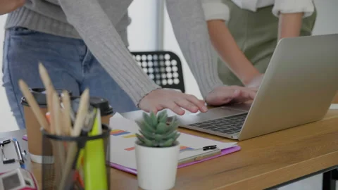 Close up of hands planning information tasks on laptop. Group of businesspeople  Stock Footage 159884572