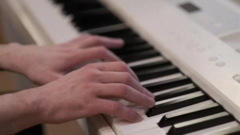 Close-Up Hands Playing Digital Piano in Natural Indoor Light Stock Footage 331905254