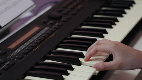 Close up of hands playing an electronic keyboard piano Video stock 348402192