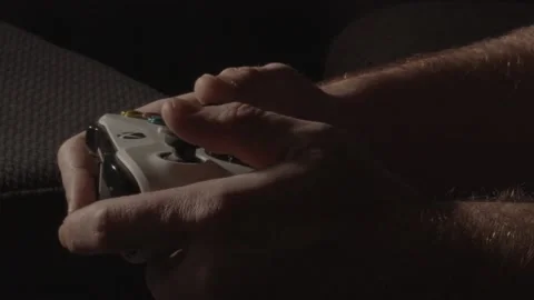 Close up of hands playing frantically on a videogame controller in a dark Stock Footage 221756894