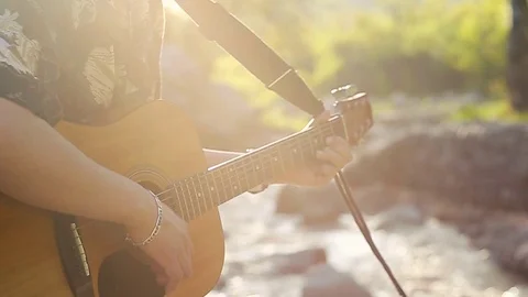 Close up of hands playing the guitar in the beautiful sunset slow motion Stock Footage 76009959