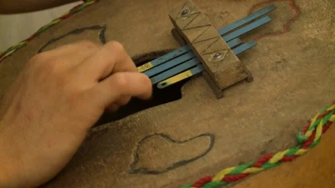 Close-up of hands playing handmade ethnic musical instrument. Stock Footage 166551960