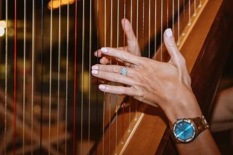 Close-Up of Hands Playing a Harp with Precision Stock Photos