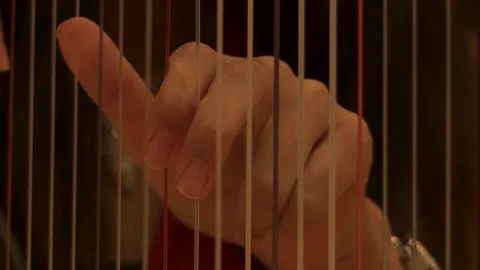 Close-Up of Hands Playing Harp Strings Stock Footage 296845528