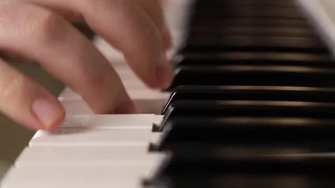 Close-up of hands playing a melody on white piano or synthesizer keys Stock Footage 303359541
