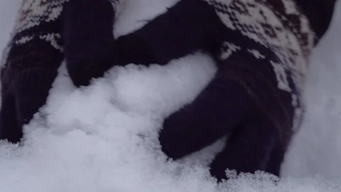 Close up of hands playing with powdery fluffy snow. Wearing woven gloves. Stock Footage 147903726