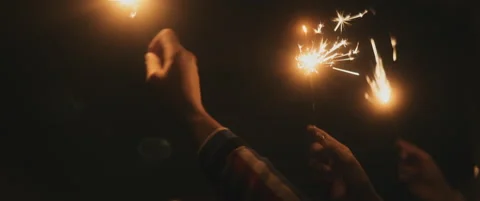 Close up of hands playing with the shiny sparkler Stock Footage 202258635