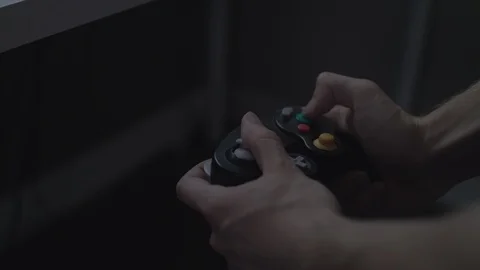 Close up of hands playing with/using a colorful black video game controller. Stock Footage 90211389