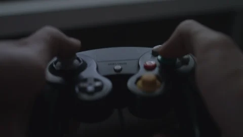 Close up of hands playing with/using a colorful black video game controller. Stock Footage 90211517