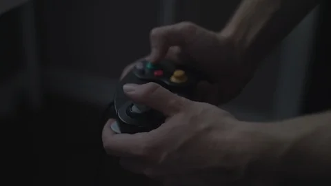 Close up of hands playing with/using a colorful black video game controller. Stock Footage 90211592
