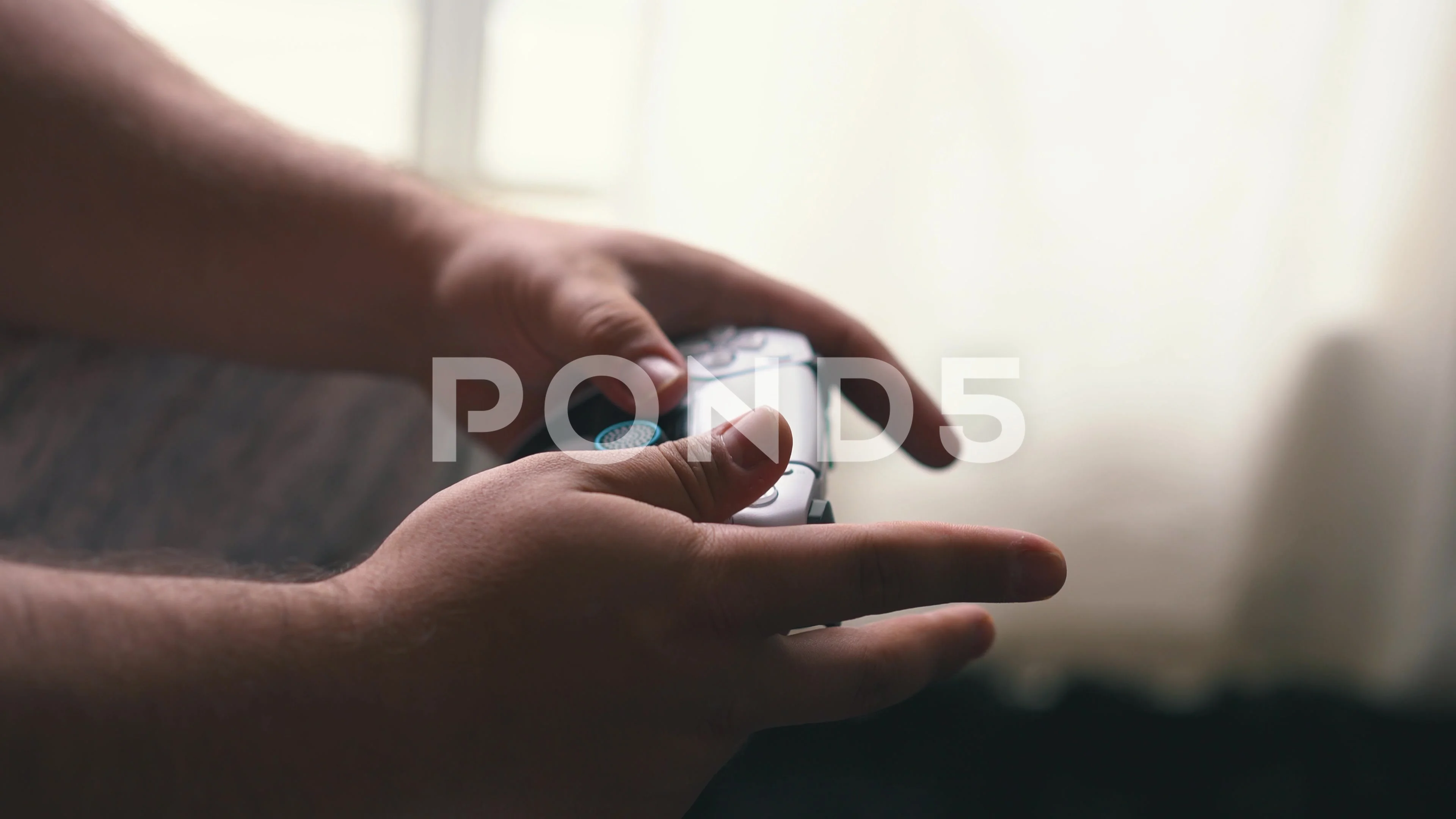 Close up of hands playing video game