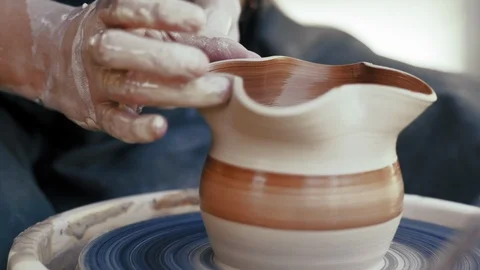 Close-up, Hands of potter Attach Form to Clay Pot on Potter's Circle Stock Footage 121156185