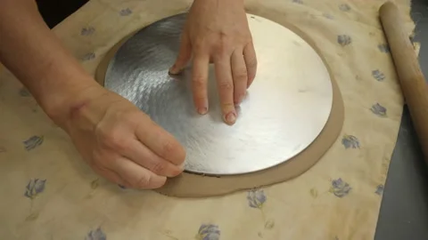 Close-up of the hands of a Potter, making a blank for the future plate. 動画素材 148855130