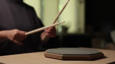 Close-up of hands practicing drum rudiments on a practice pad Stock Footage 341737571